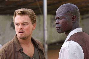 Leonardo DiCaprio and Djimon Hounsou are momentarily distracted by a three-headed monkey.
