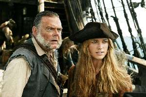 Kevin McNally smells a foul wind a-brewing.  Keira Knightley whistles innocently.