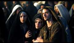 Sandy people, including Monica Bellucci in the middle as Mary Magdalene.