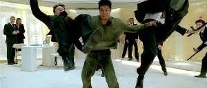 Jet Li tries to fly out of trouble by flapping two goons, with limited success.