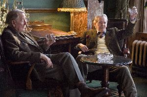 Peter O'Toole raises his glass to Leslie Phillips and hot young totty.